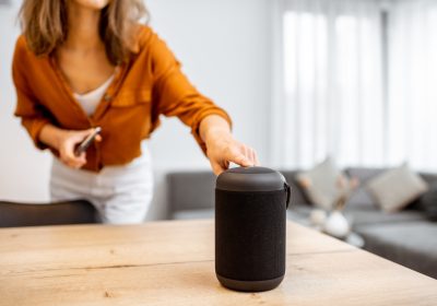 Woman with smart wireless column at home